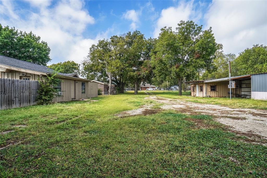 207 School House Road Paradise, TX 76073 - Photo 33 of 33 a backyard of a house with table and chairs and wooden fence