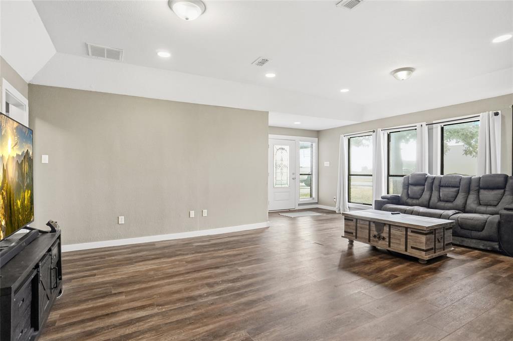 207 School House Road Paradise, TX 76073 - Photo 6 of 33 a living room with furniture and a flat screen tv