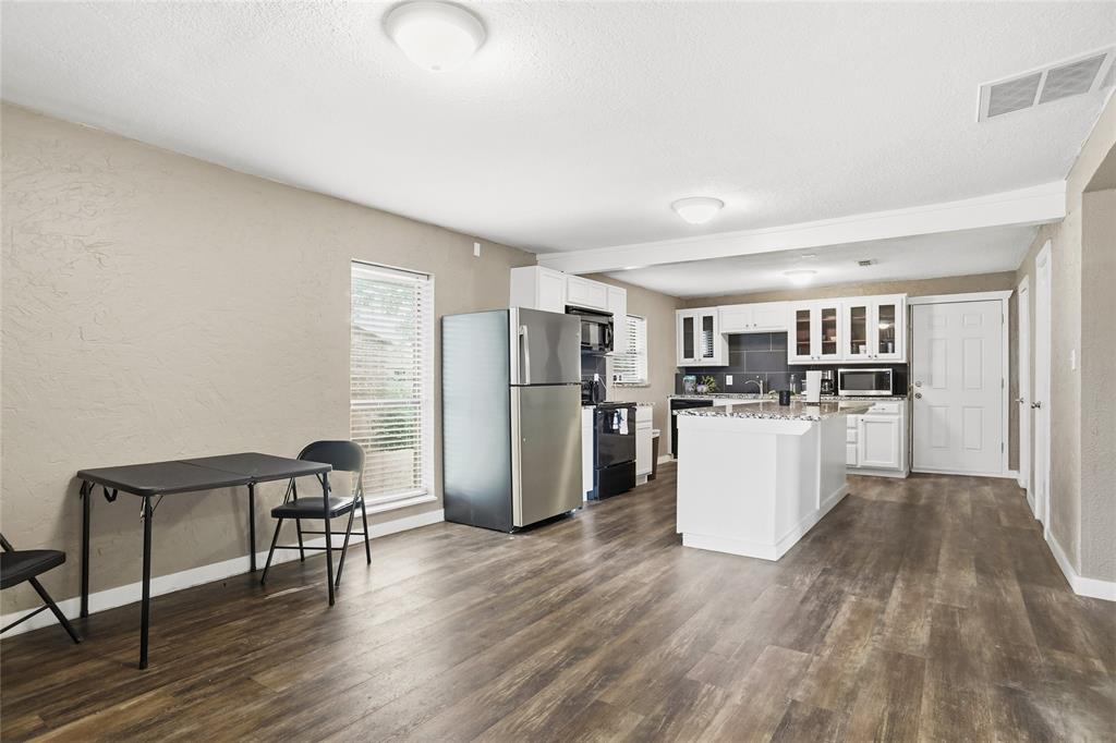 207 School House Road Paradise, TX 76073 - Photo 10 of 33 a view of kitchen with stainless steel appliances refrigerator stove microwave and cabinets