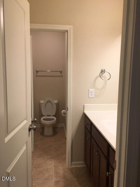 134 Zante Currant Road, Unit 134 Durham, NC 27703 - Photo 11 of 14 a bathroom with a granite countertop sink and a mirror