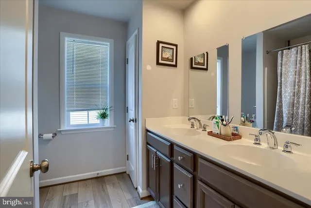 a bathroom with a double vanity sink and a mirror