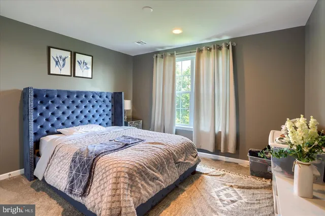 a bedroom with a bed and a couch