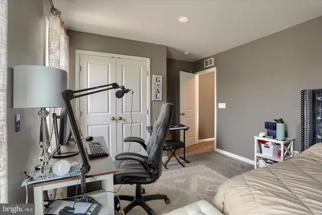 a bedroom with furniture and a wooden floor