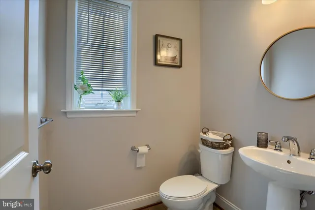 a white toilet sitting next to a bathroom sink