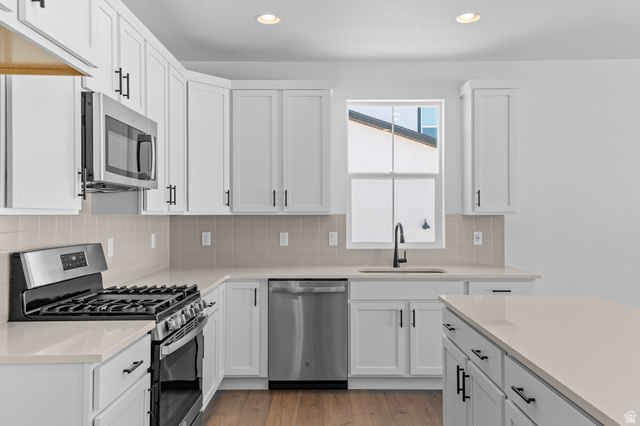 3016 West 2650 North Clinton, UT 84015 - Photo 16 of 20 Kitchen with stainless steel appliances, white cabinets, and recessed lighting
