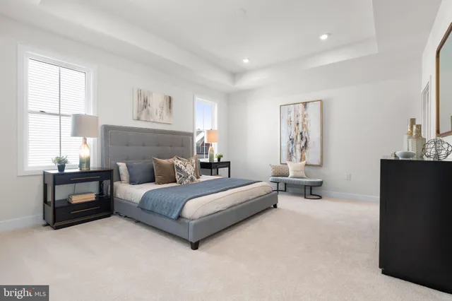 a spacious bedroom with a bed and wooden floor