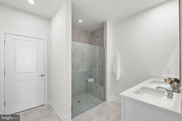 a bathroom with a shower sink and mirror