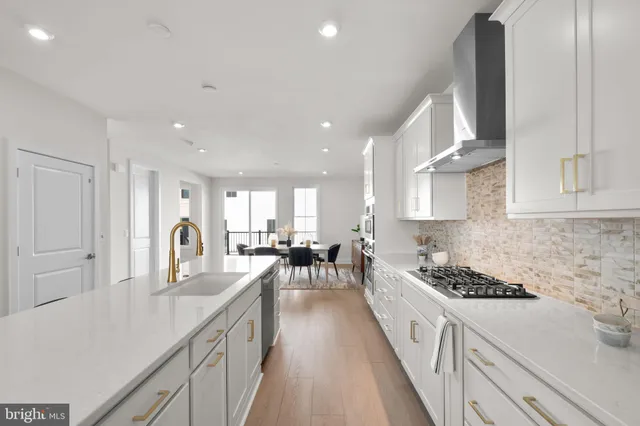 a kitchen with stainless steel appliances kitchen island granite countertop a lot of counter space and a sink