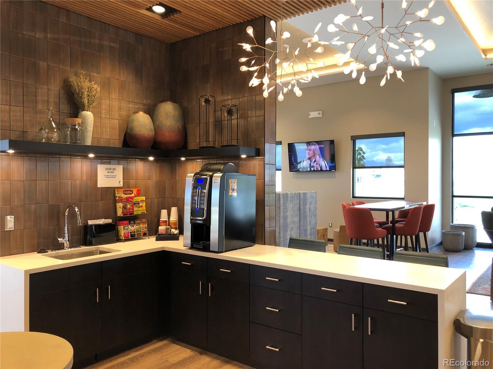 12865 Bay Street Firestone, CO 80504 - Photo 12 of 22 a kitchen with a sink cabinets and chandelier