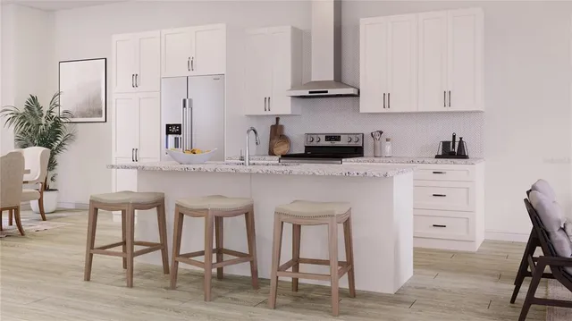 a kitchen with white cabinets and counter space