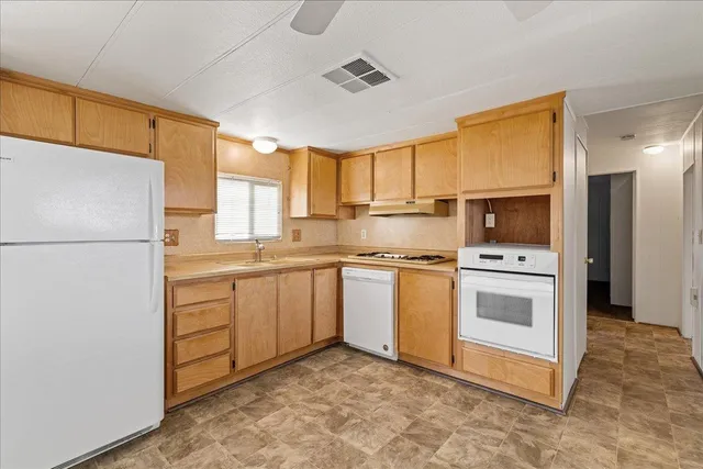 a kitchen with white cabinets and white appliances