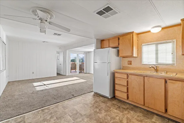 a spacious bathroom with a sink and a refrigerator