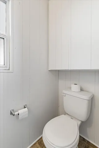 a white toilet sitting next to a bathroom sink