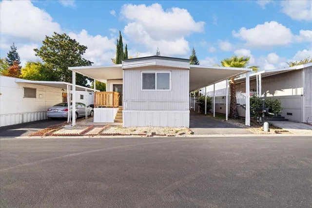 a backyard of a house with barbeque oven and outdoor seating