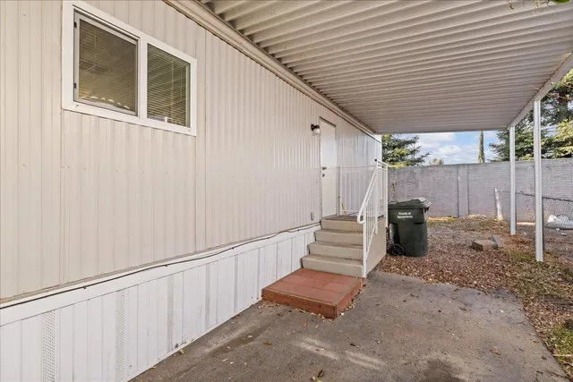 a view of a patio with table and chairs