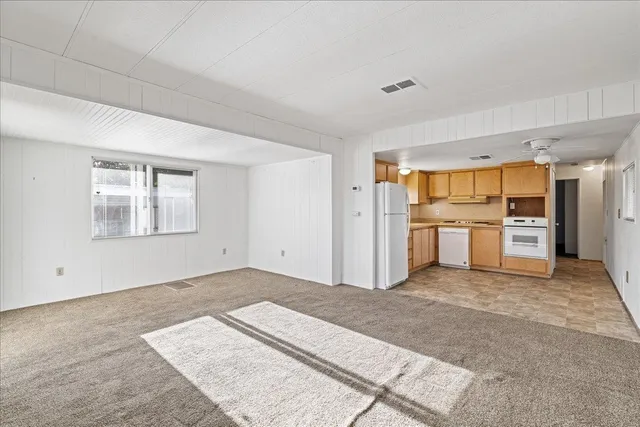 a view of a kitchen with wooden cabinet and refrigerator