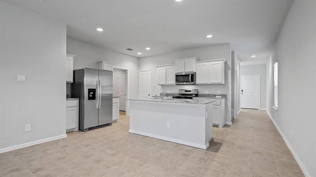 120 Mojave Road Boyd, TX 76023 - Photo 7 of 40 a kitchen with white cabinets and stainless steel appliances