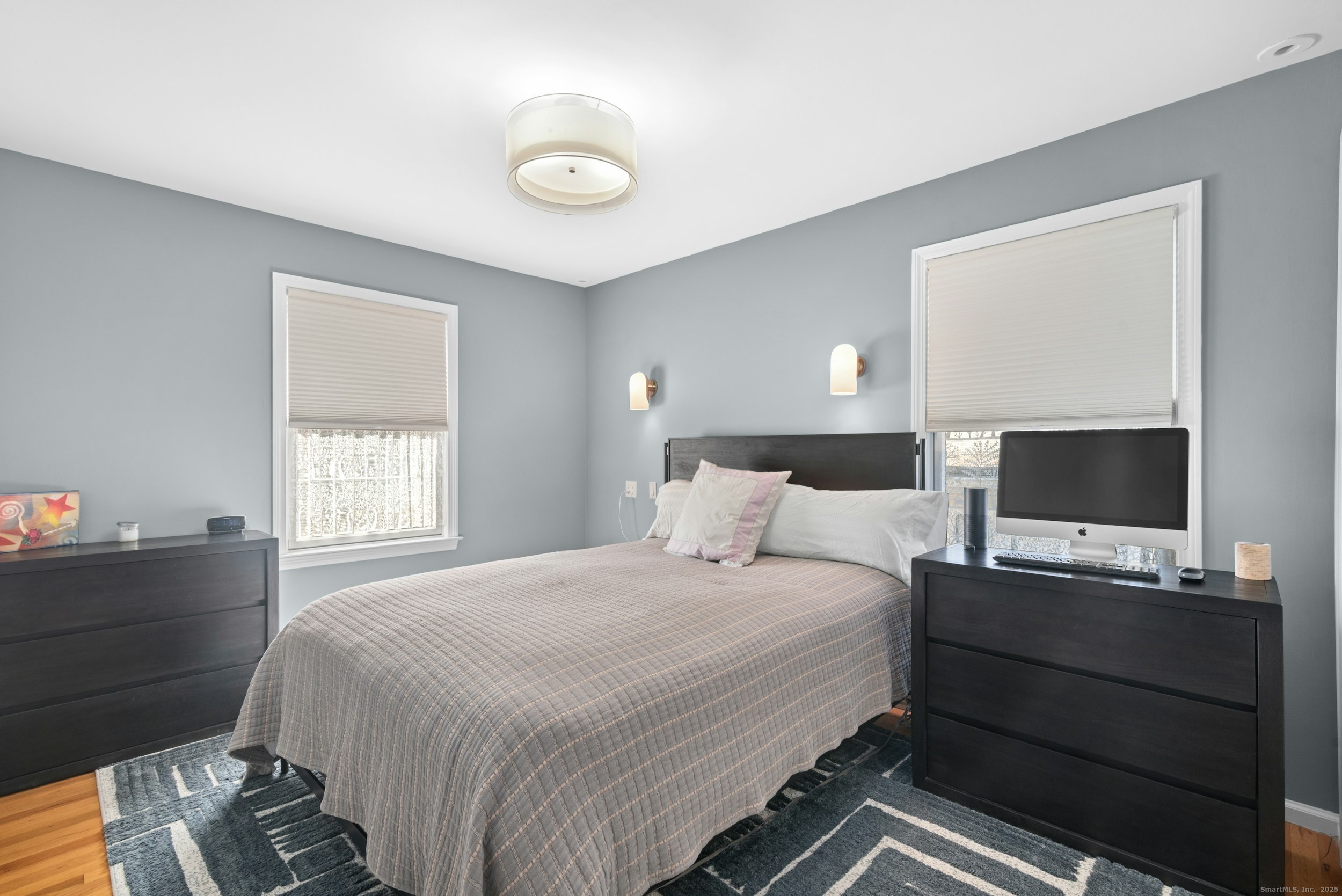 85 Hirsch Road Stamford, CT 06905 - Photo 19 of 27 a bedroom with a bed and a flat screen tv