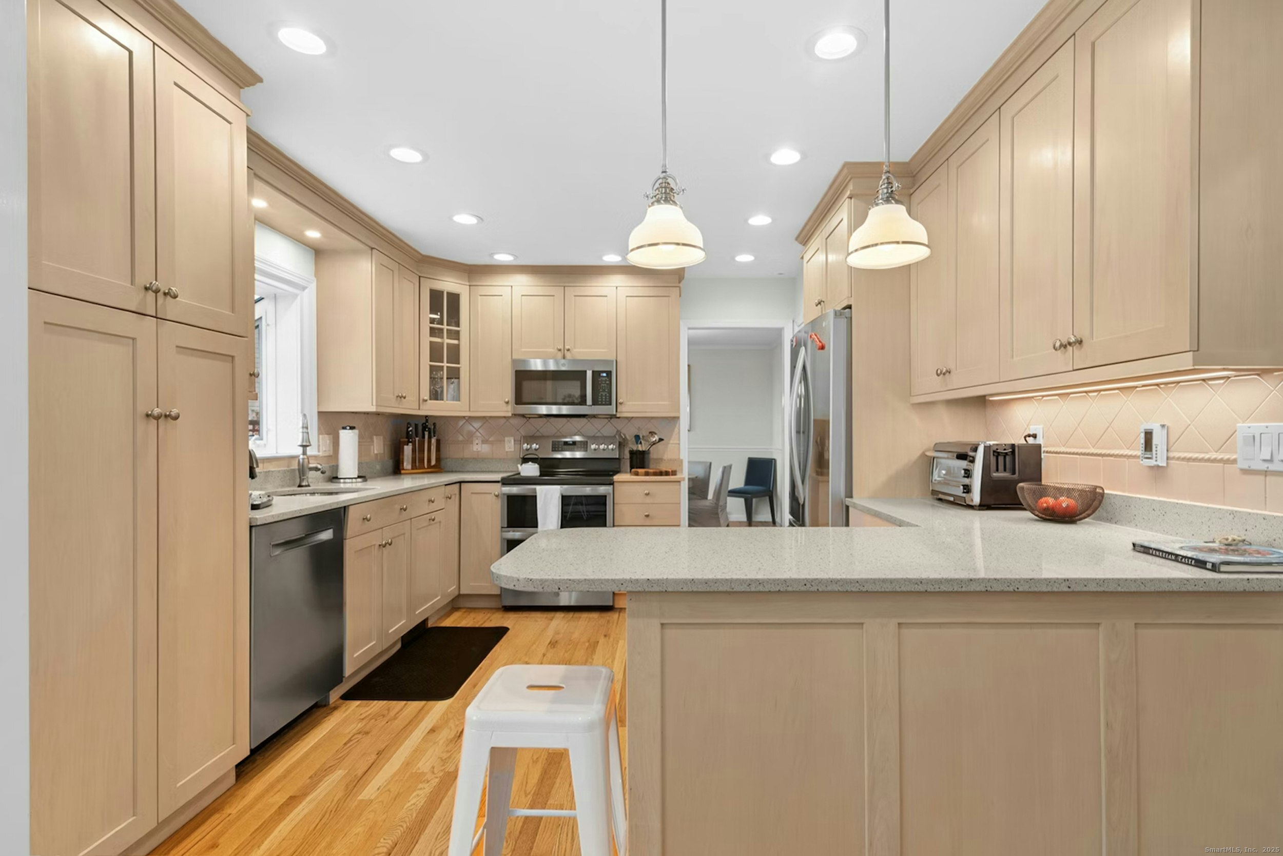 85 Hirsch Road Stamford, CT 06905 - Photo 9 of 27 a kitchen with stainless steel appliances granite countertop a refrigerator a sink dishwasher a stove and white cabinets with wooden floor