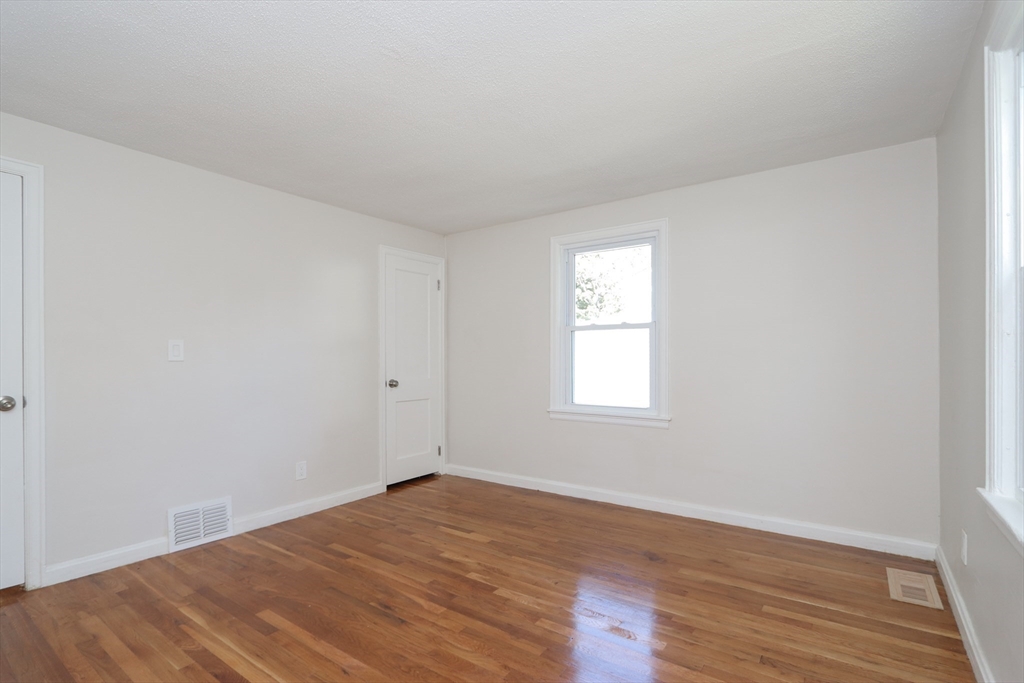 32 Lotus Street West Springfield, MA 01089 - Photo 15 of 42 an empty room with wooden floor and windows