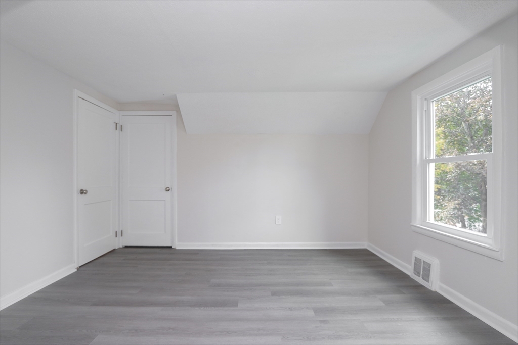 32 Lotus Street West Springfield, MA 01089 - Photo 31 of 42 a view of an empty room with wooden floor and a window