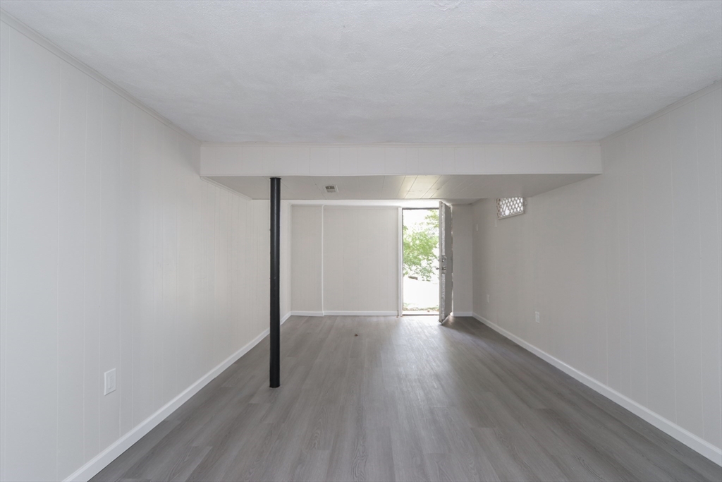 32 Lotus Street West Springfield, MA 01089 - Photo 35 of 42 a view of an empty room with wooden floor and a window