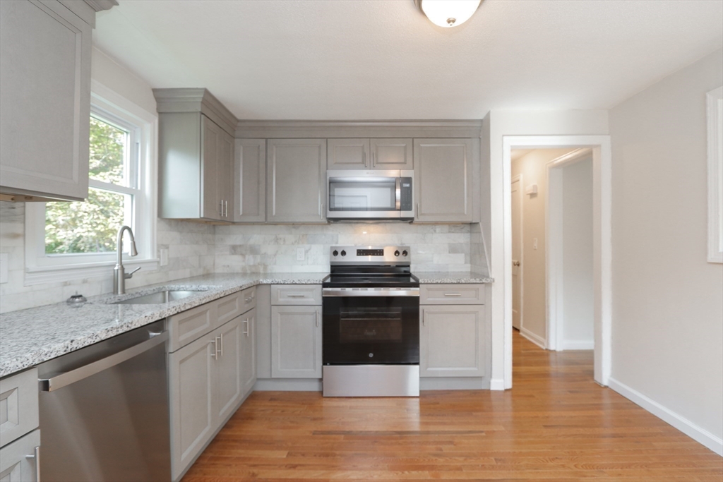 32 Lotus Street West Springfield, MA 01089 - Photo 4 of 42 a kitchen with a stove top oven sink and cabinets