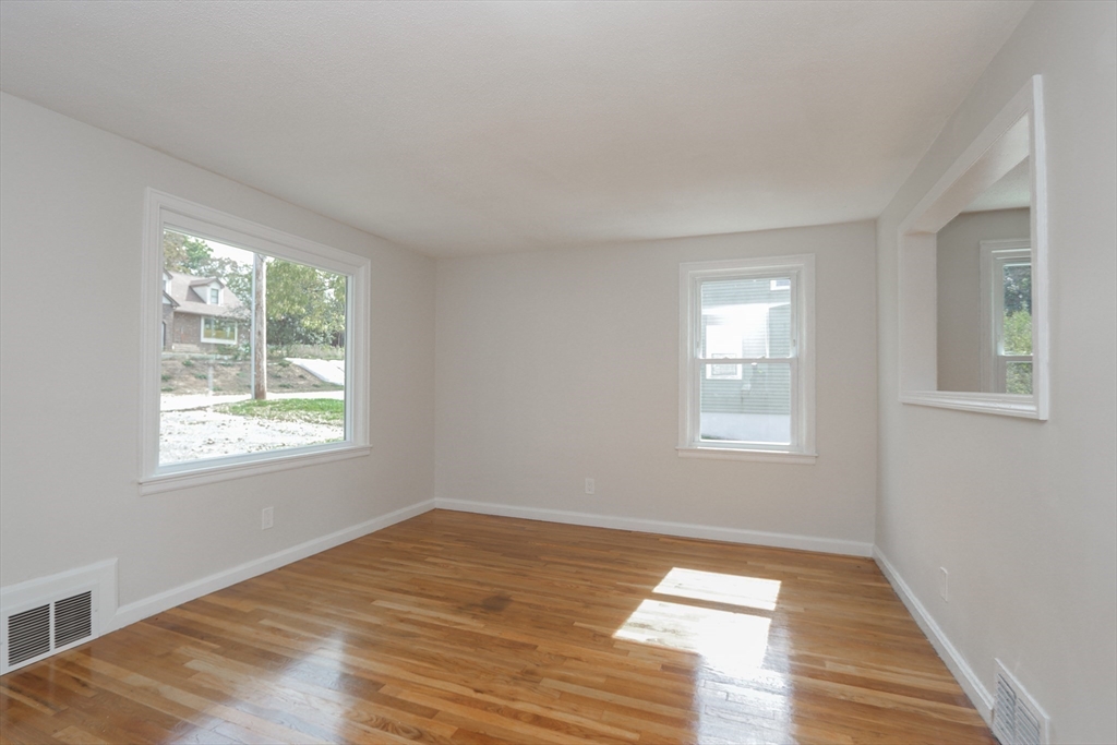 32 Lotus Street West Springfield, MA 01089 - Photo 9 of 42 a view of an empty room with wooden floor and a window