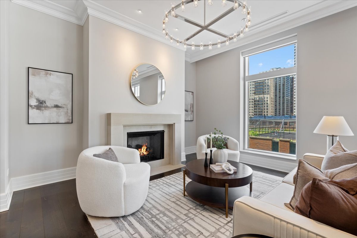 9 West Walton Street, Unit 702 Chicago, IL 60610 - Photo 4 of 38 a living room with furniture and a fireplace