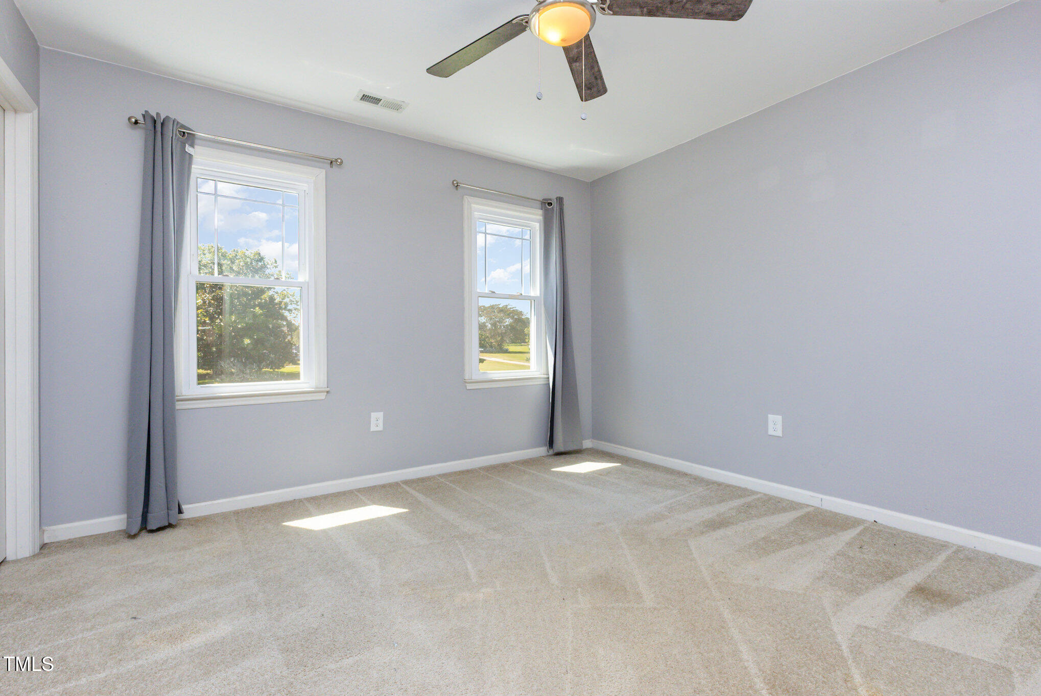 823 Shadow Lake Drive Willow Spring, NC 27592 - Photo 18 of 31 a view of an empty room with a window