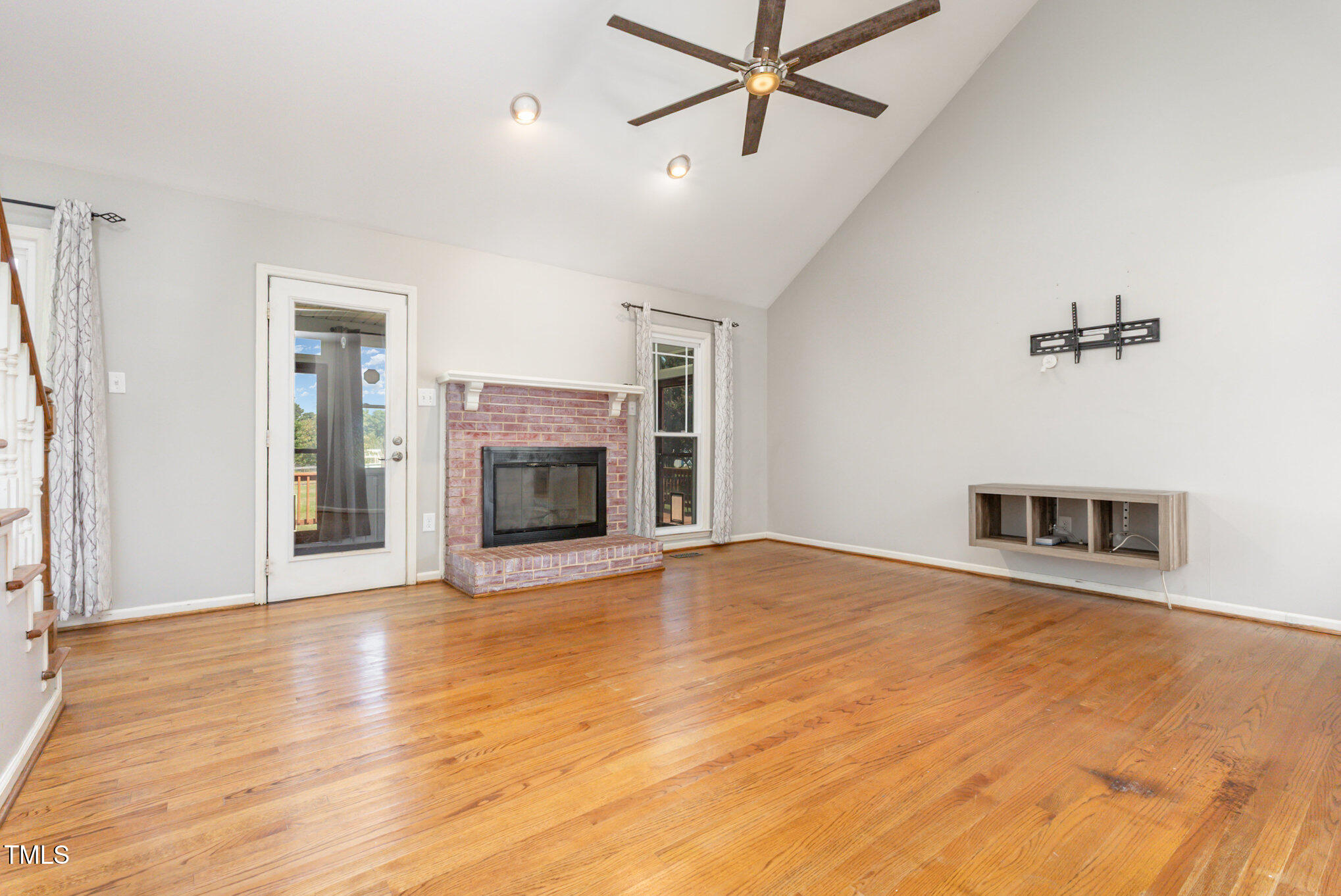 823 Shadow Lake Drive Willow Spring, NC 27592 - Photo 8 of 31 wooden floor fireplace and windows in an empty room
