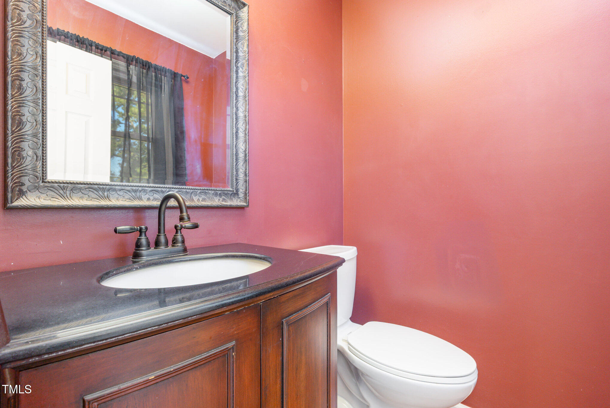 823 Shadow Lake Drive Willow Spring, NC 27592 - Photo 10 of 31 a bathroom with a sink a toilet and mirror