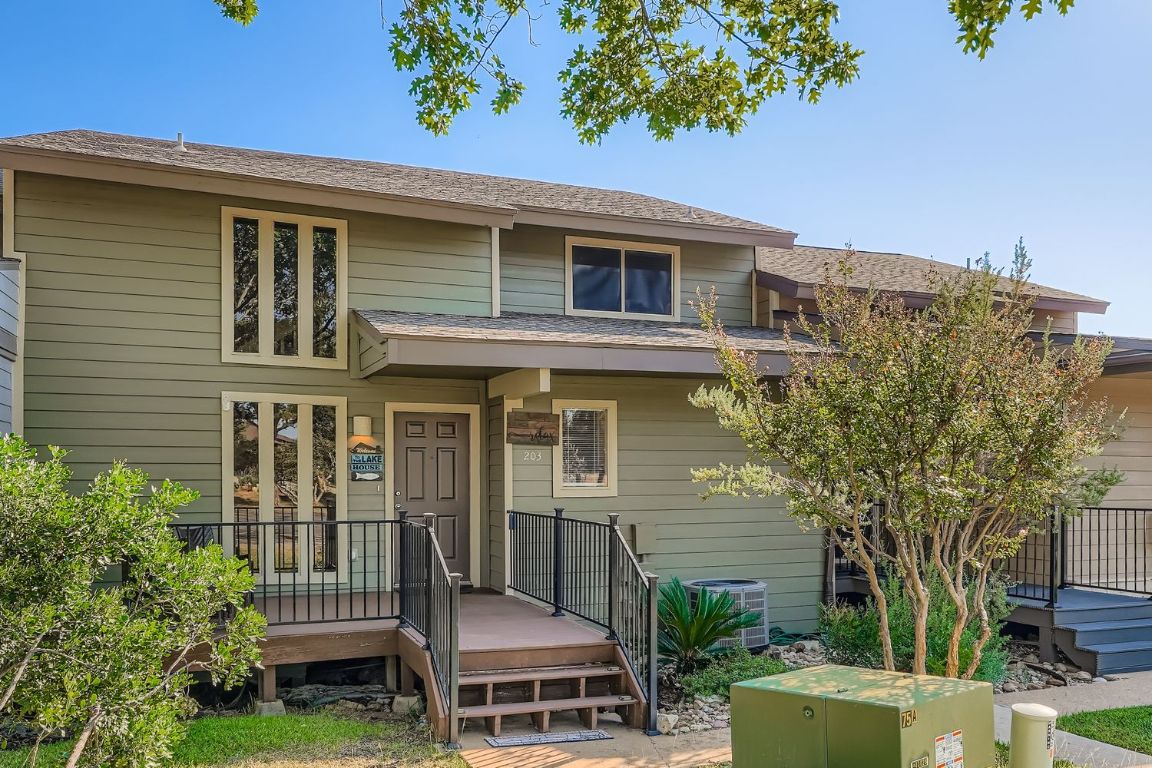 a view of a house with a chairs in patio