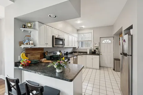 a kitchen with sink cabinets and appliances
