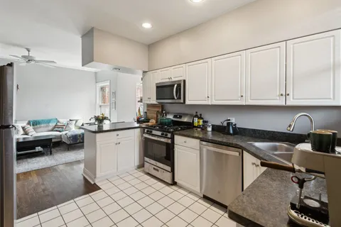 a kitchen with stainless steel appliances granite countertop a sink and cabinets