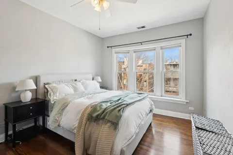 a spacious bedroom with a bed and a window