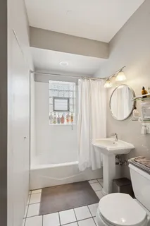 a bathroom with a toilet a sink and a mirror