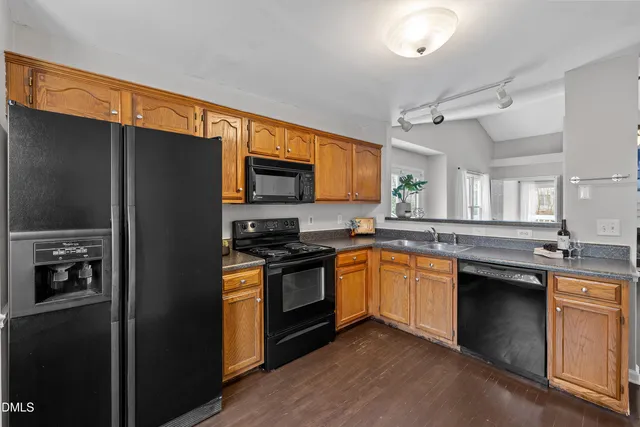 a view of a room with wooden floor and a window