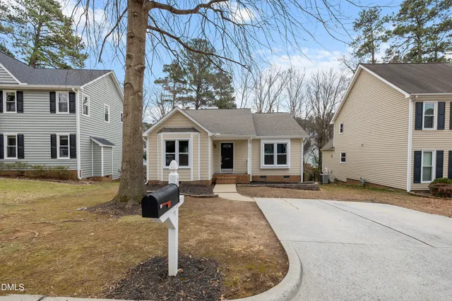 a view of a house with a wooden deck