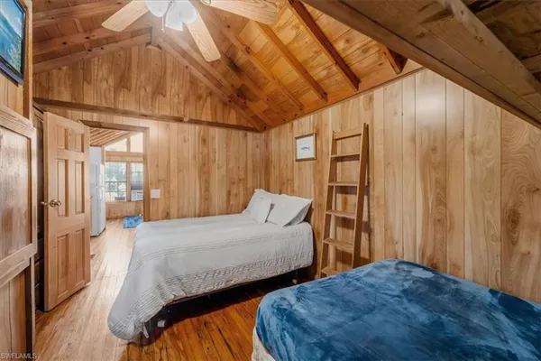 a bedroom with a bed a dresser and a window