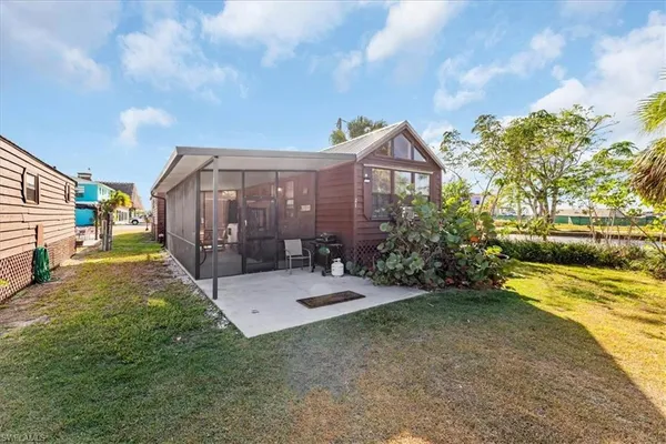 a view of a house with a yard and pathway