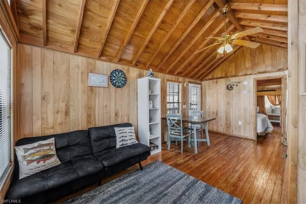 a living room with furniture and wooden floor
