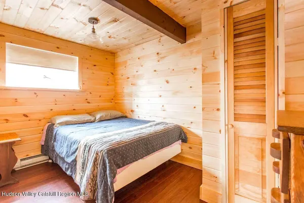a bed sitting in a bedroom next to a window