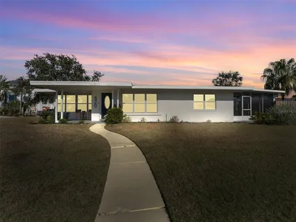 a front view of house with yard outdoor seating and green space