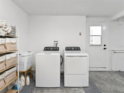 a view of a patio with a table and chairs