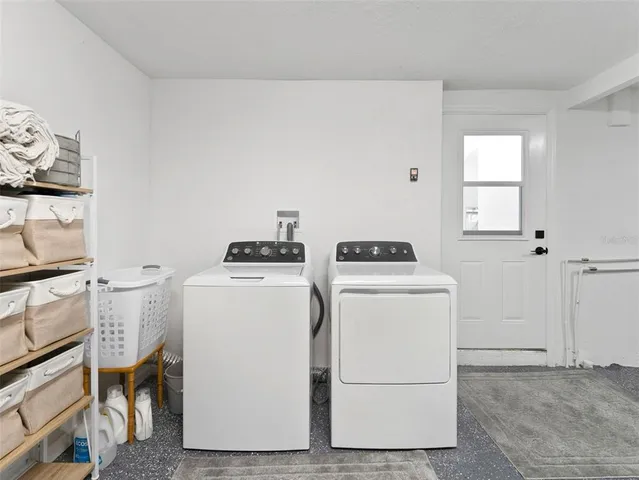 a view of a patio with a table and chairs