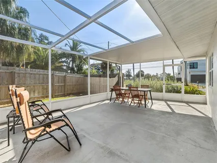 a backyard of a house with table and chairs