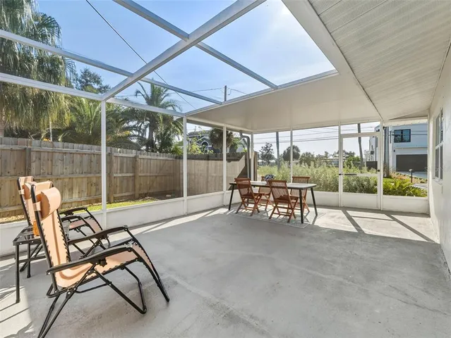 a backyard of a house with table and chairs