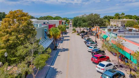 a view of a patio with dining table and chairs under an umbrella