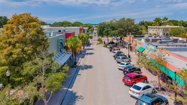a view of a patio with dining table and chairs under an umbrella